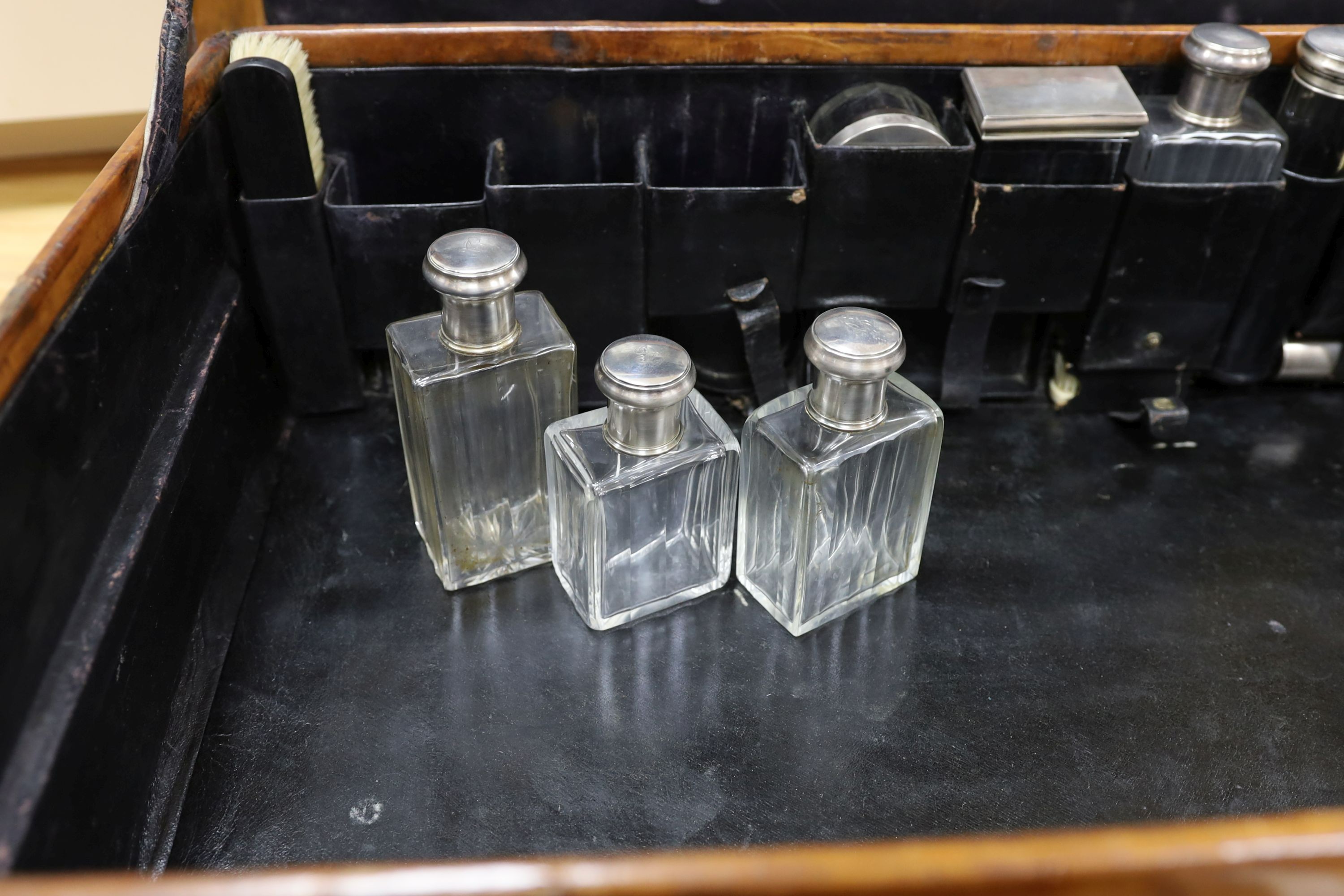 A Dupont travel suitcase, initialled ‘L.C.’ with French white metal mounted bottles